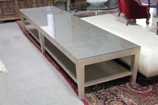 Appraisal: CONTEMPORARY COFFEE TABLE Long rectangular table with silvered finish lower