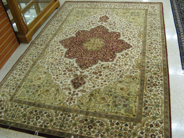 Appraisal: HAND KNOTTED ORIENTAL CARPET Indo-Persian overall scrolling floral raceme decoration