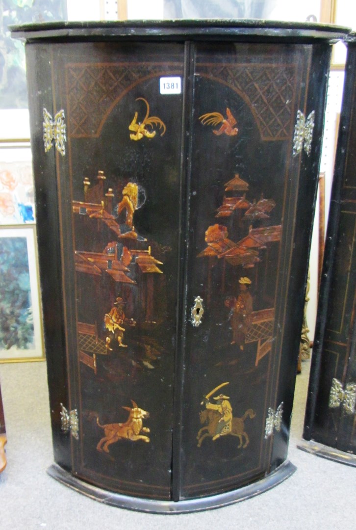 Appraisal: An th century black lacquer chinoiserie decorated bowfront hanging two