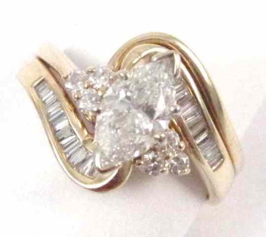 Appraisal: DIAMOND AND FOURTEEN KARAT GOLD RING featuring a marquise-cut diamond