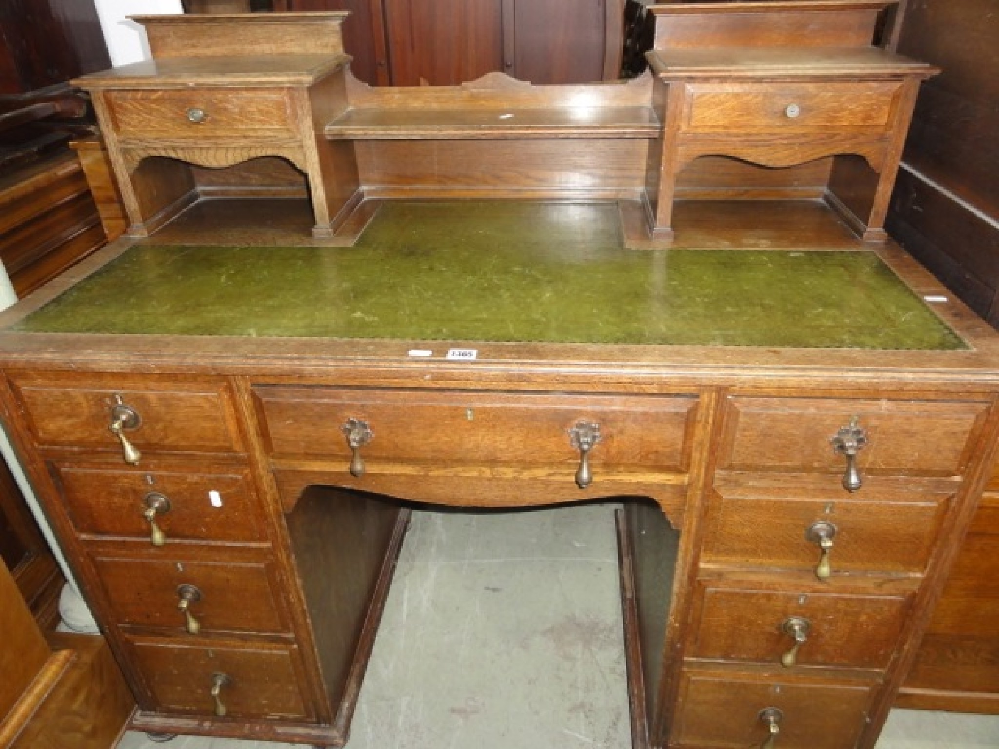 Appraisal: An Edwardian oak kneehole twin pedestal writing desk the shallow