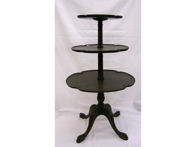 Appraisal: Three-tiered oval Chippendale style tea table on four-foot pedestal