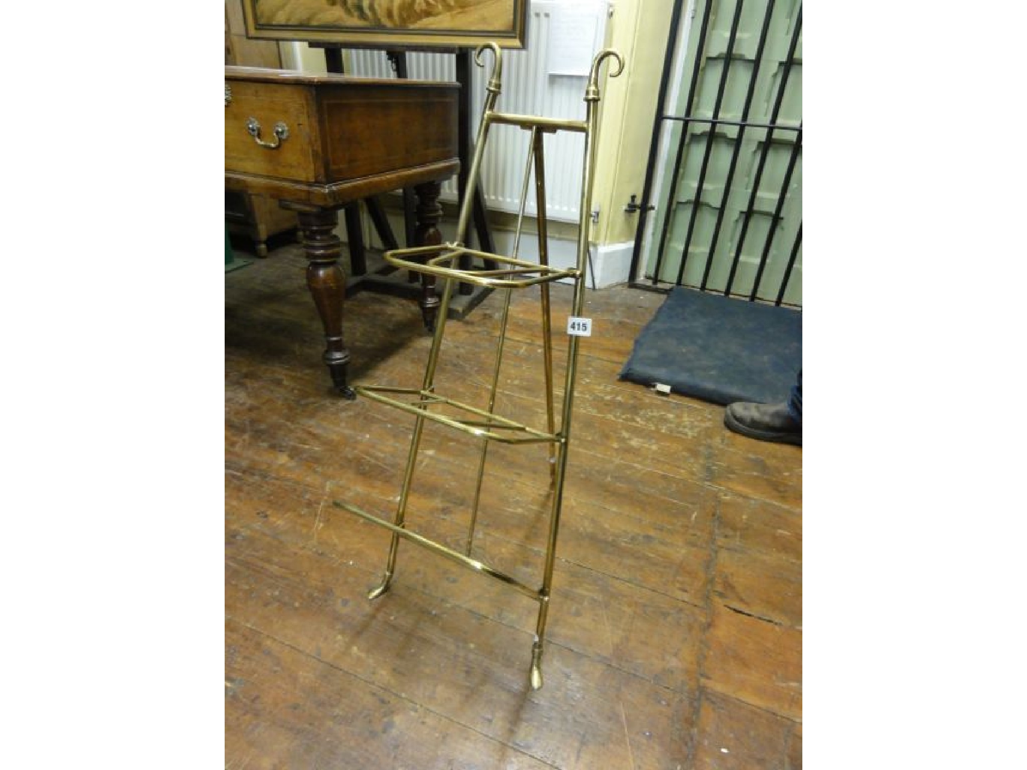 Appraisal: A Victorian brass three tier magazine rack with easel framework