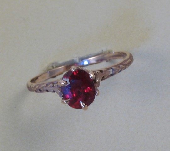 Appraisal: RUBY AND FOURTEEN KARAT GOLD RING set with an oval-cut