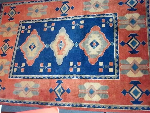 Appraisal: A TURKISH BLUE GROUND RUG with central panel and wide