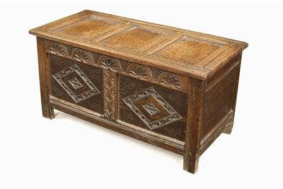 Appraisal: An oak chest with a triple panelled top and a