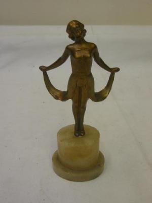 Appraisal: AN ART DECO SPELTER FIGURE modelled as a female holding