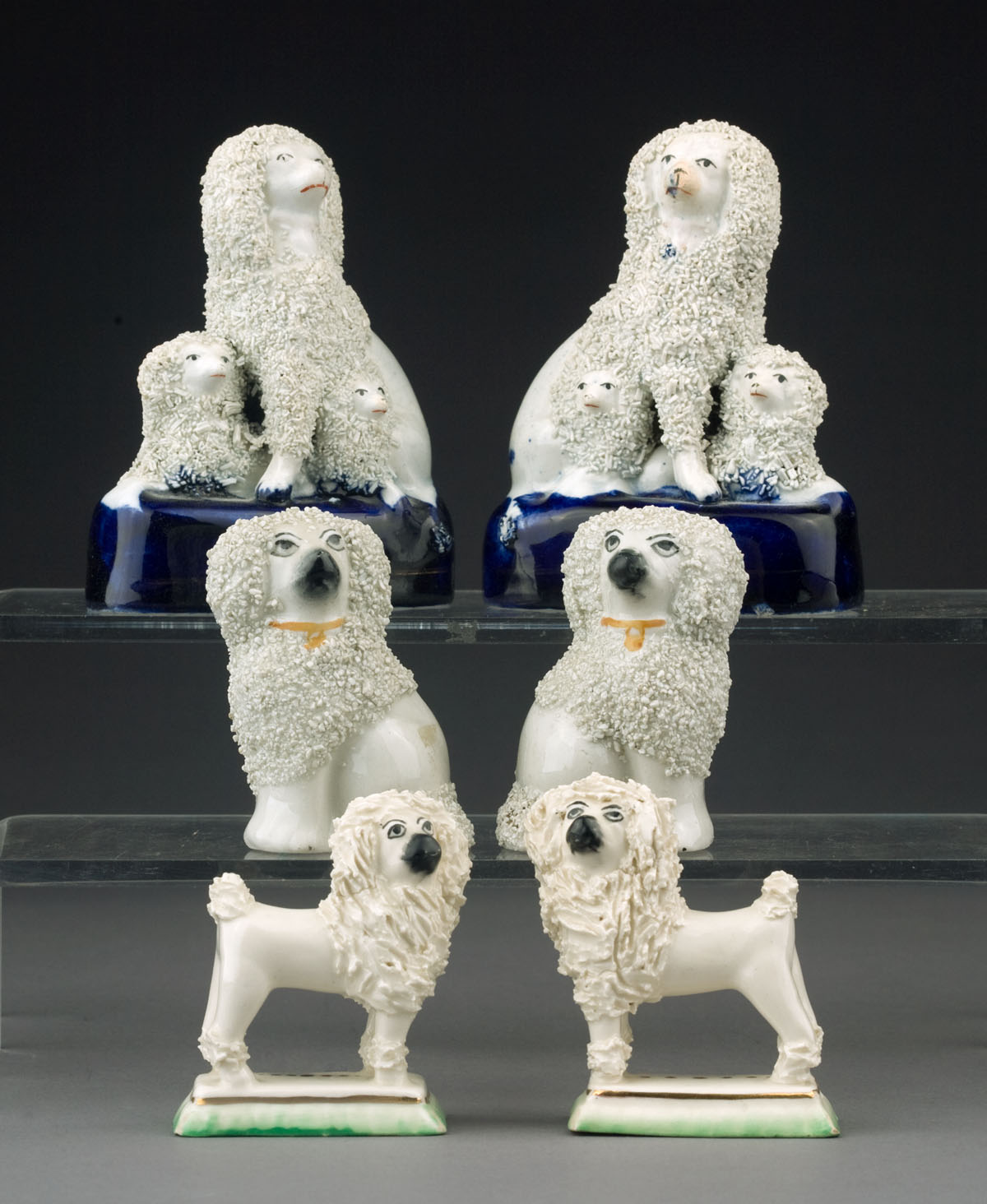 Appraisal: GROUP OF STAFFORDSHIRE POTTERY AND PORCELAIN FIGURES OF POODLES MID-NINETEENTH