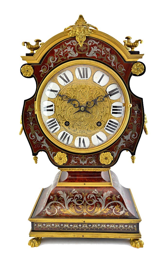 Appraisal: A Louis XIV style ormolu mounted 'tete-de-poupee' mantel clock th