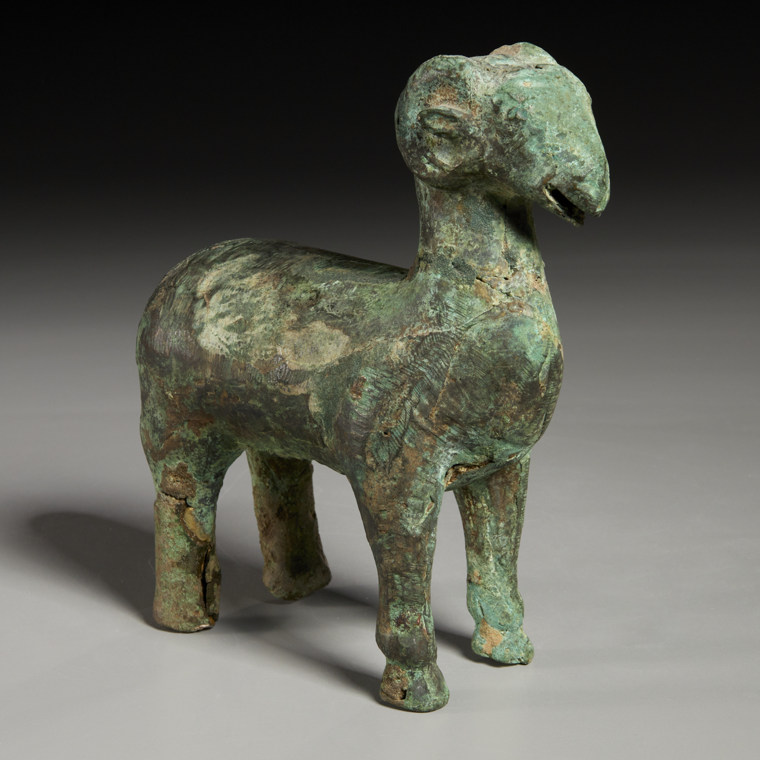 Appraisal: ARCHAIC HAN-STYLE CHINESE BRONZE FIGURE OF A RAM Possibly of