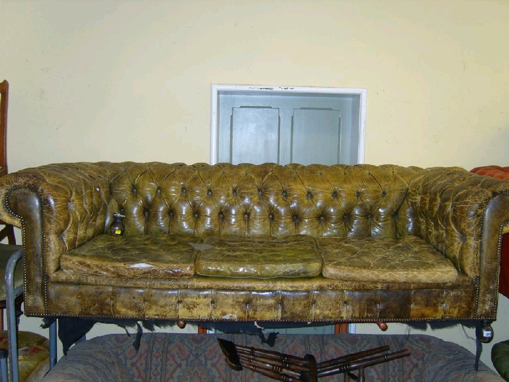 Appraisal: An Edwardian -seat button back Chesterfield sofa with distressed green