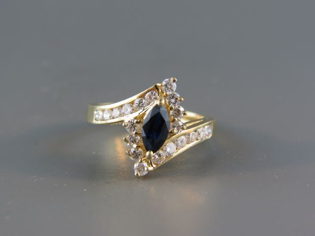 Appraisal: Sapphire Diamond Ring rich blue marquise gem weighing carat surrounded