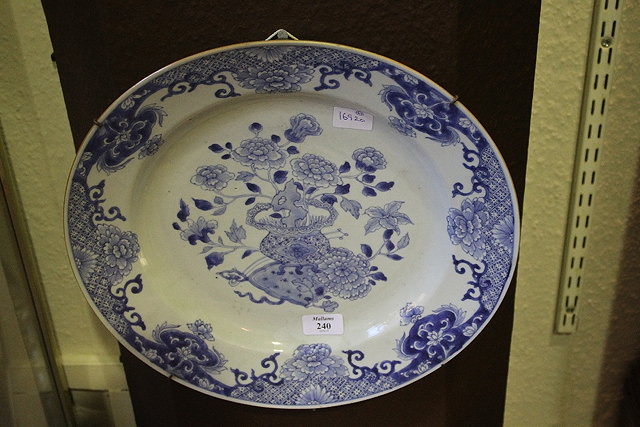 Appraisal: A CHINESE BLUE AND WHITE CHARGER with central vase of