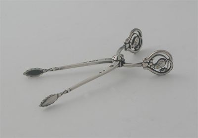 Appraisal: By Georg Jensen a small pair of Danish 'sprung' sugar