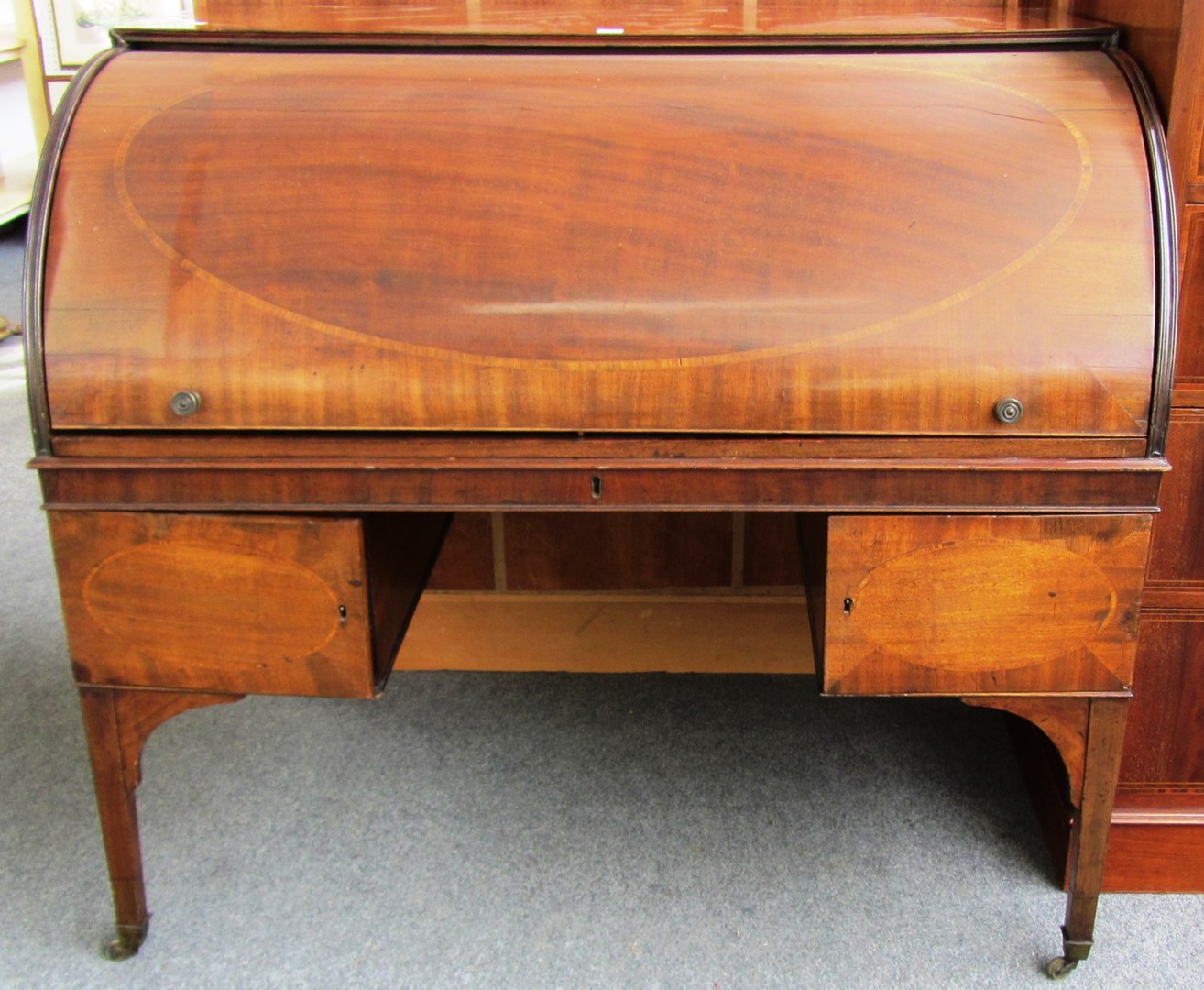 Appraisal: A George III mahogany roll top desk with fitted interior