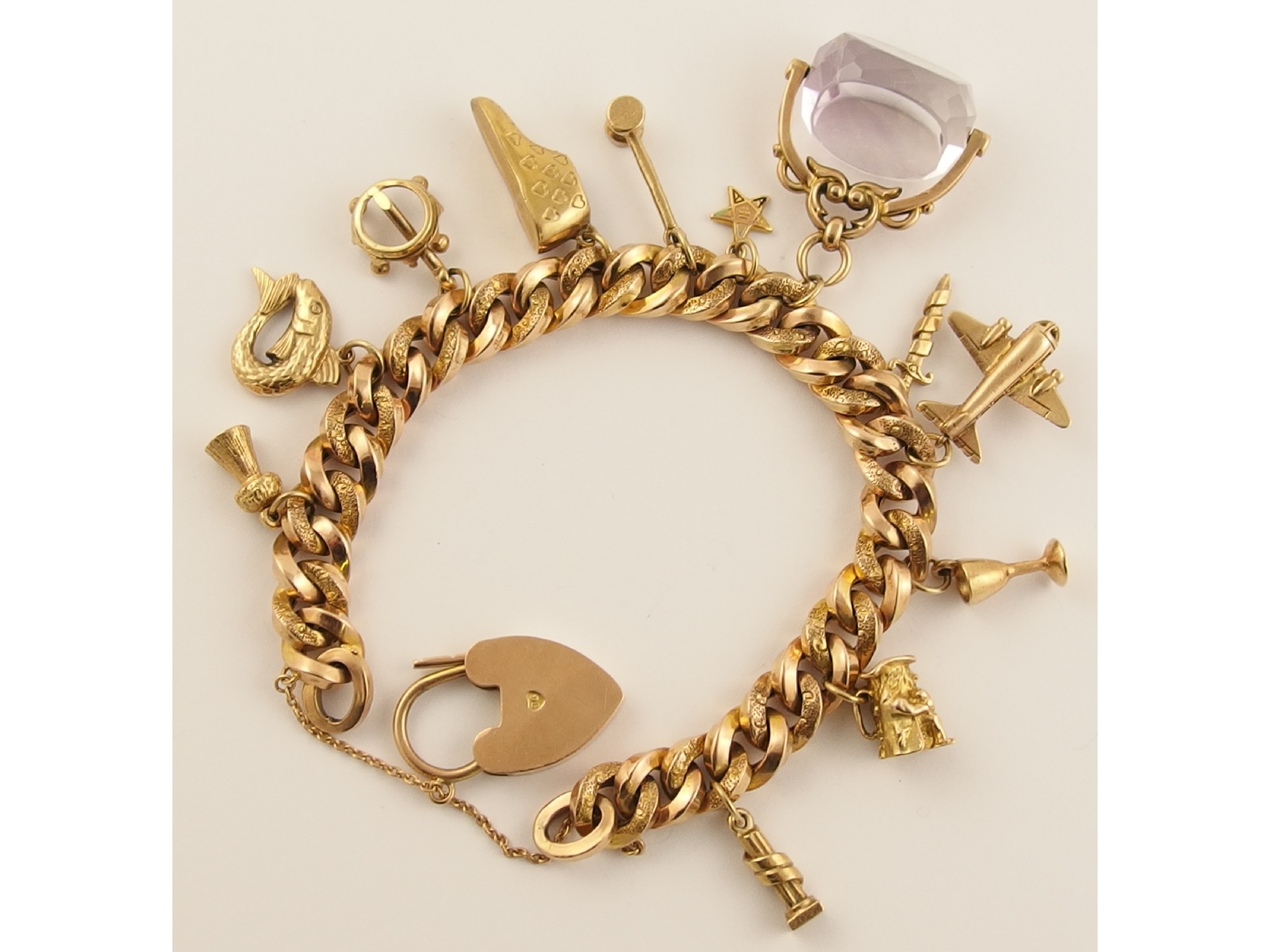 Appraisal: A ct charm bracelet with attached amethyst swivel fob weight