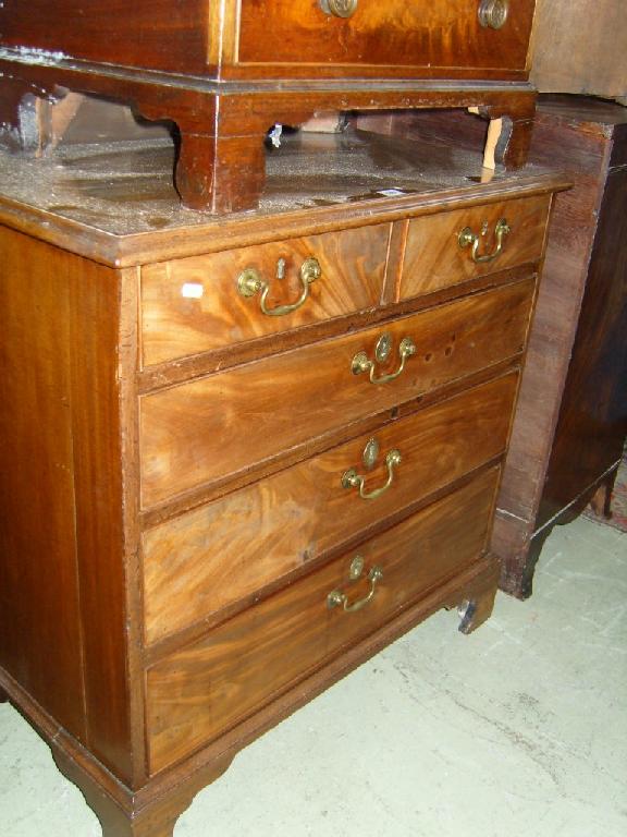 Appraisal: A small Georgian mahogany chest of long and short drawers