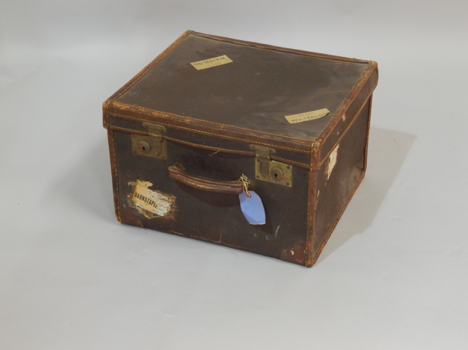 Appraisal: A small canvas and leather bound cabin trunk bearing various