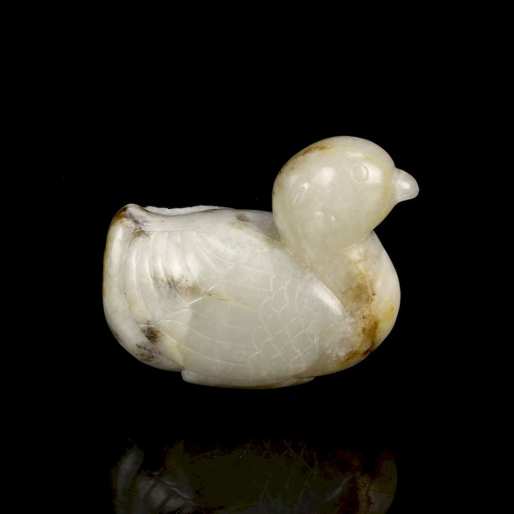 Appraisal: Celadon and Russet Jade Duck Naturalistically carved the plump recumbent