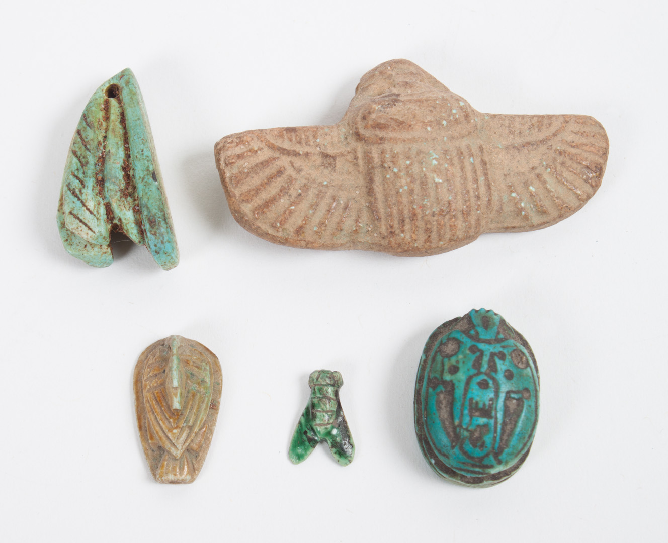 Appraisal: Five ancient Egyptian faience amulets comprising a scarab with hieroglyphics