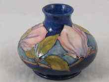 Appraisal: Moorcroft A squat vase the blue body tube lined with