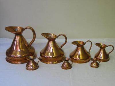 Appraisal: A SET OF SEVEN COPPER MEASURES of haystack form half