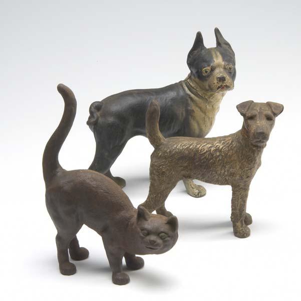 Appraisal: THREE CAST IRON DOORSTOPS Of a Boston terrier an Airedale