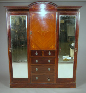 Appraisal: An Edwardian mahogany and inlaid triple wardrobe the arched cornice