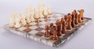 Appraisal: Carved Stone Chess Set Carved stone chess set contains board