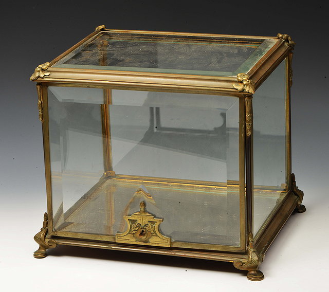 Appraisal: A TH CENTURY BEVELLED GLASS AND BRASS FRAMED TABLE CABINET