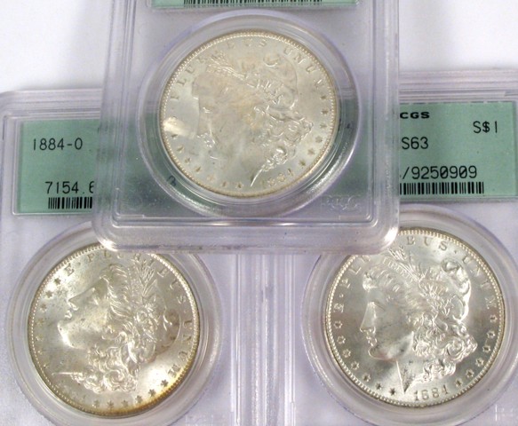 Appraisal: THREE U S SILVER MORGAN DOLLARS all -O and all