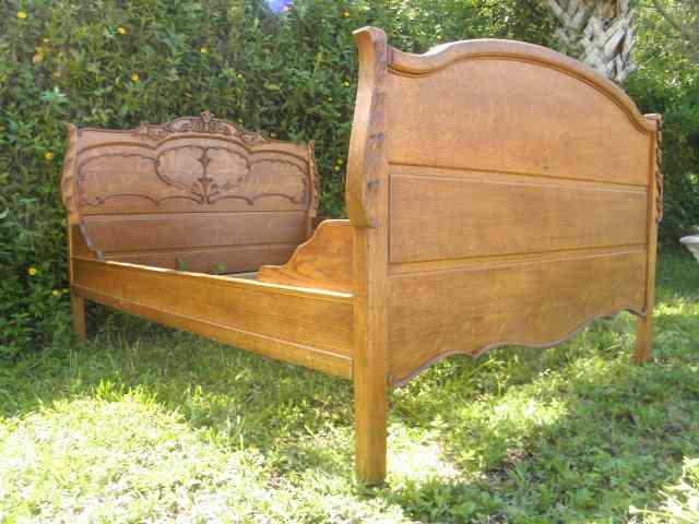 Appraisal: An antique carved oak bedframe Includes headboard footboard and rails