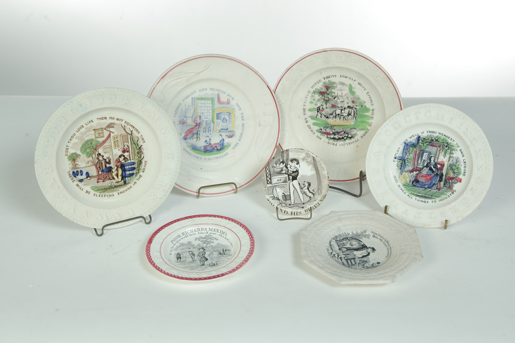 Appraisal: SEVEN CHILDRENS' MAXIM PLATES England nd half- th century Earthenware