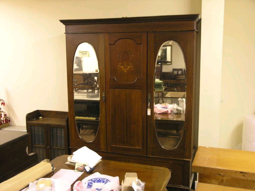 Appraisal: An Edwardian inlaid mahogany wardrobe pair of oval bevelled mirrored