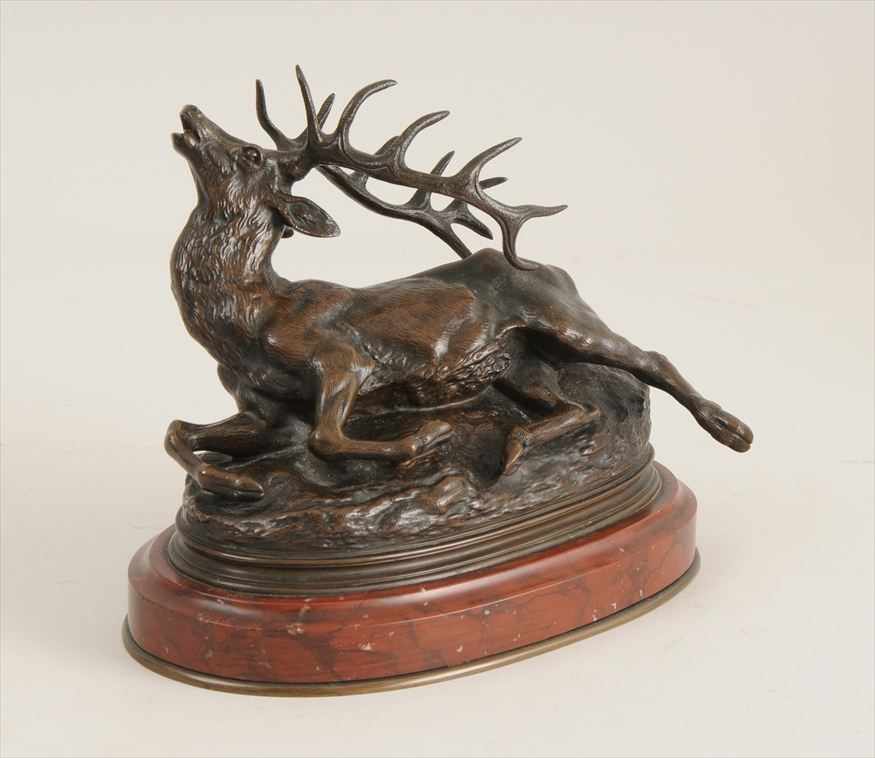 Appraisal: BRONZE MODEL OF A STAG Raised on a red marble