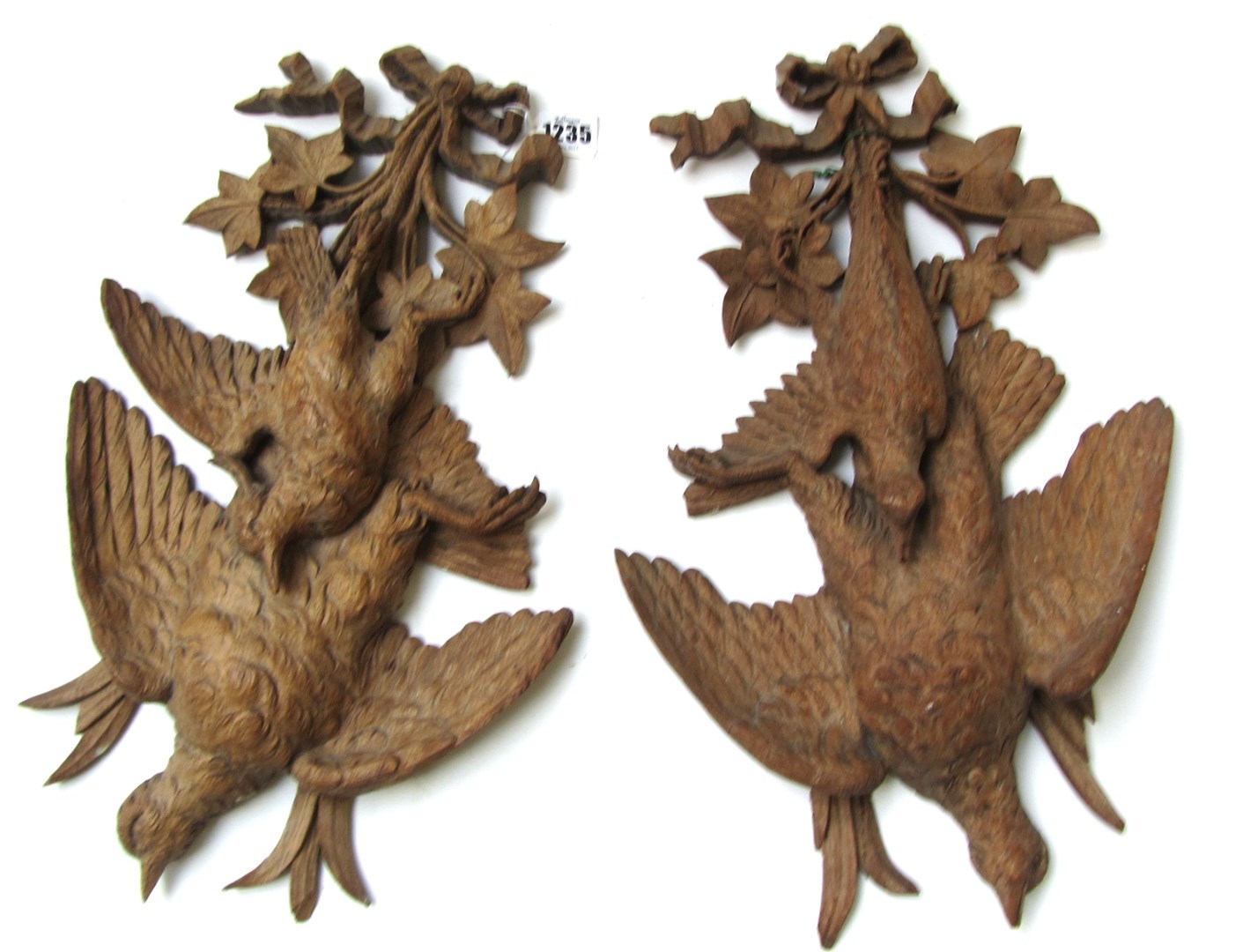 Appraisal: A pair of th century carved oak hangings of partridges