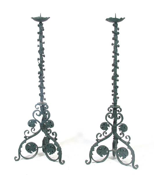 Appraisal: A pair of Baroque style wrought iron floor candlesticks height