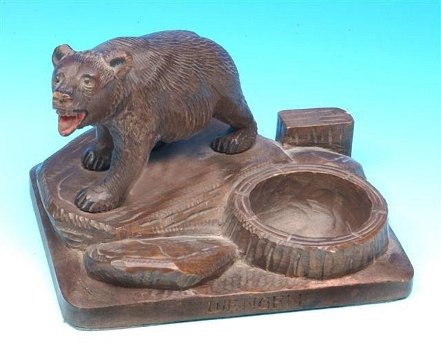 Appraisal: A carved German Black Forest Bear walking across a rock