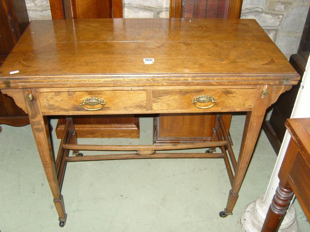 Appraisal: A Victorian rosewood fold over top card table incorporating two