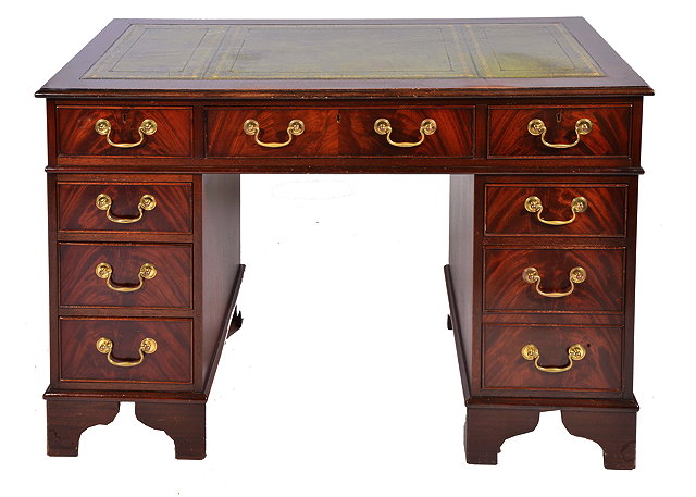 Appraisal: A MAHOGANY PEDESTAL DESK with leather inset top and brass