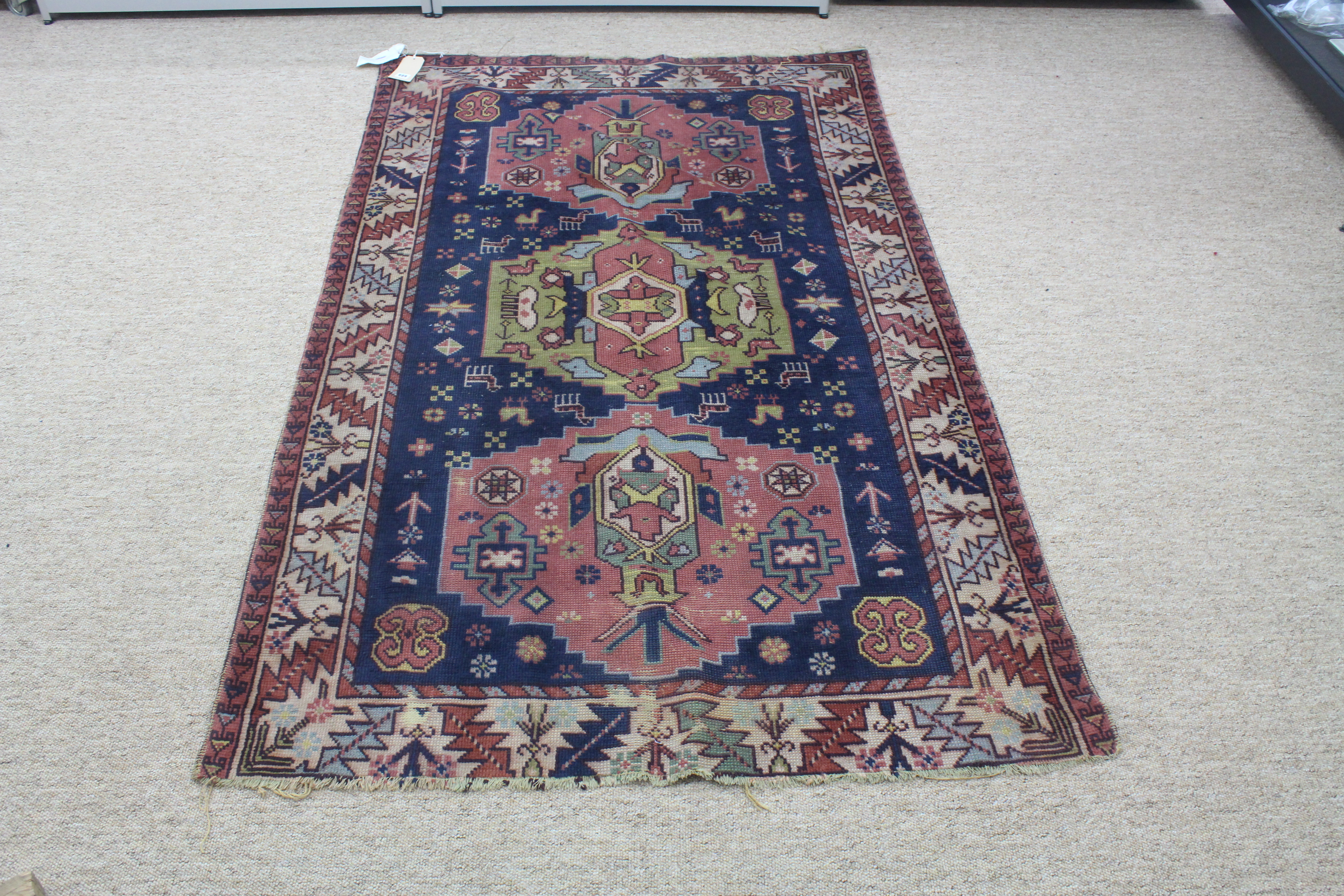 Appraisal: A South Caucasian rug with three hexagonal medallions on a