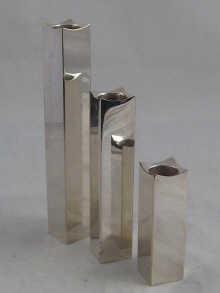 Appraisal: A set of three graduated silver plated candle holders by