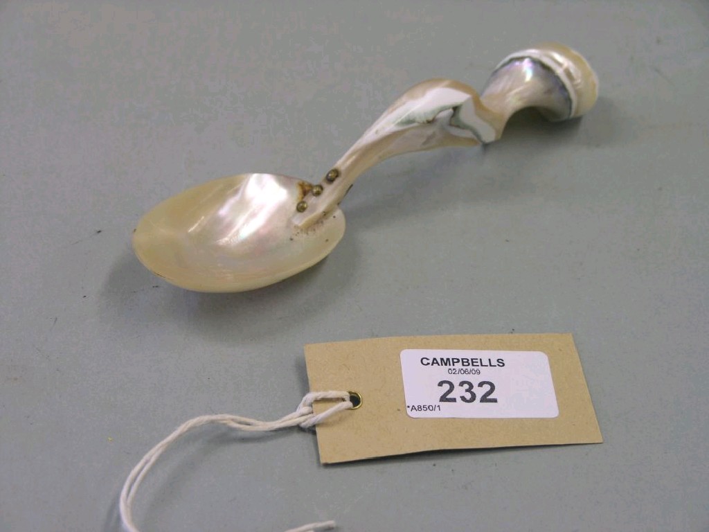 Appraisal: A mother of pearl spoon with pearl handle in and