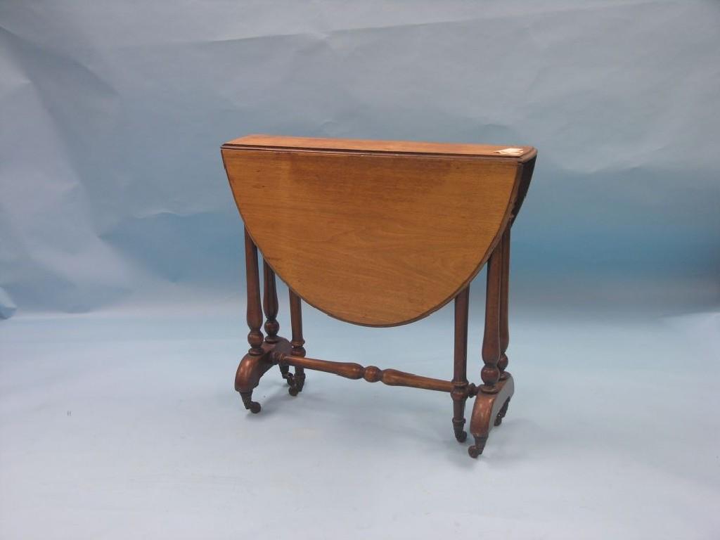 Appraisal: A Victorian walnut Sutherland table on twin-turned end supports with