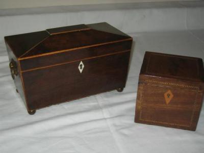 Appraisal: A MAHOGANY TEA CADDY of sarcophagus form with stringing brass