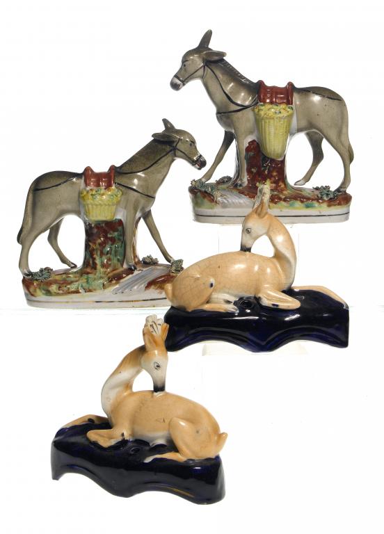 Appraisal: A PAIR OF STAFFORDSHIRE EARTHENWARE MODELS OF MULES AND A