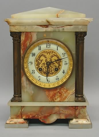 Appraisal: Circular porcelain dial with gilt bezel flanked by twin gilt