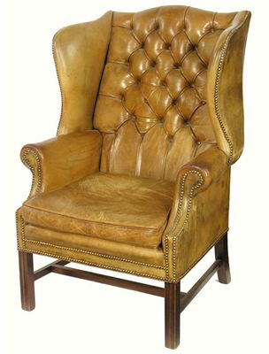 Appraisal: A wing armchair in George III style with brass studded