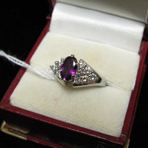 Appraisal: PURPLE GEMSTONE DIAMOND AND FOURTEEN KARAT WHITE GOLD RING Centered