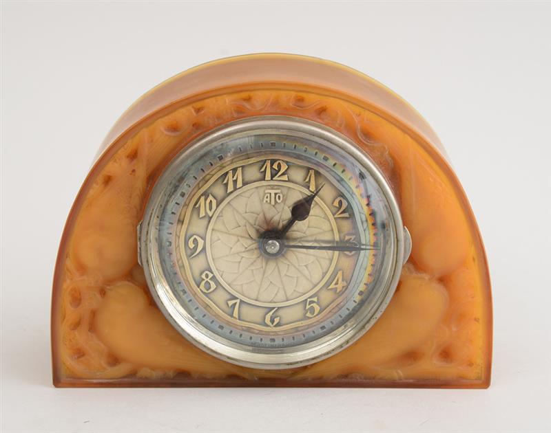 Appraisal: FRENCH ART DECO PRESSED AMBER GLASS MANTLE CLOCK The silver-plate